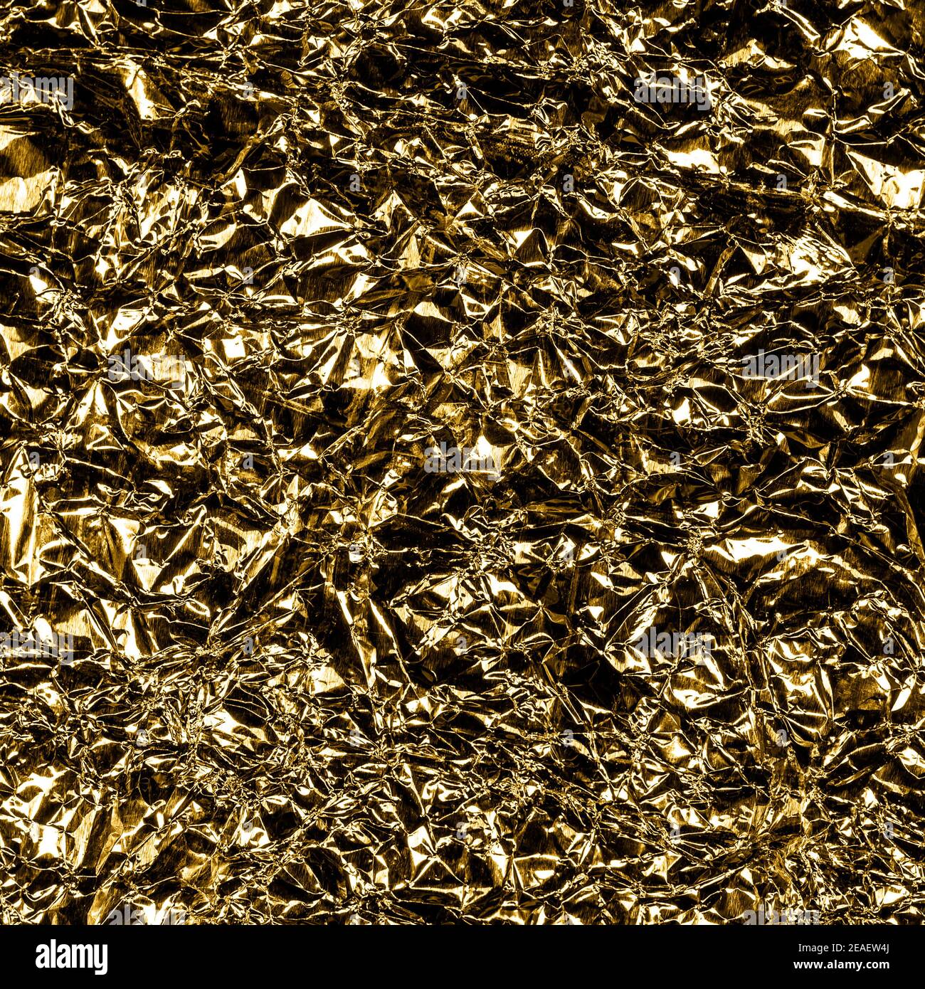 Crumpled Aluminum Foil Background Texture - in Gold Color Stock Photo
