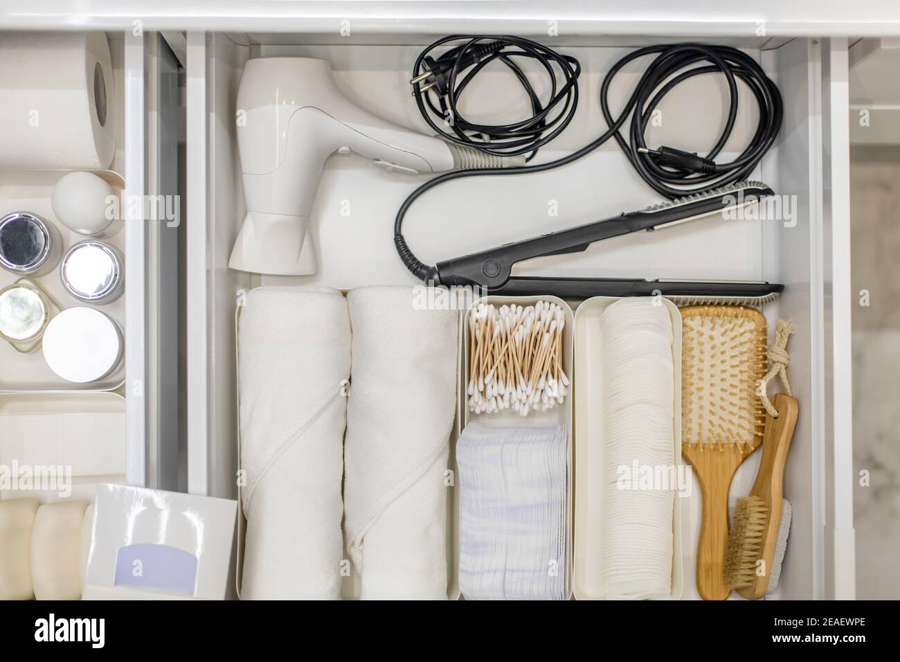 Bathroom under sink organizer drawers with neatly placed bath amenities