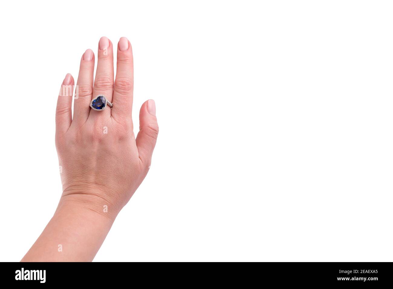Heart shaped blue sapphire precious ring on woman hand isolated on ...