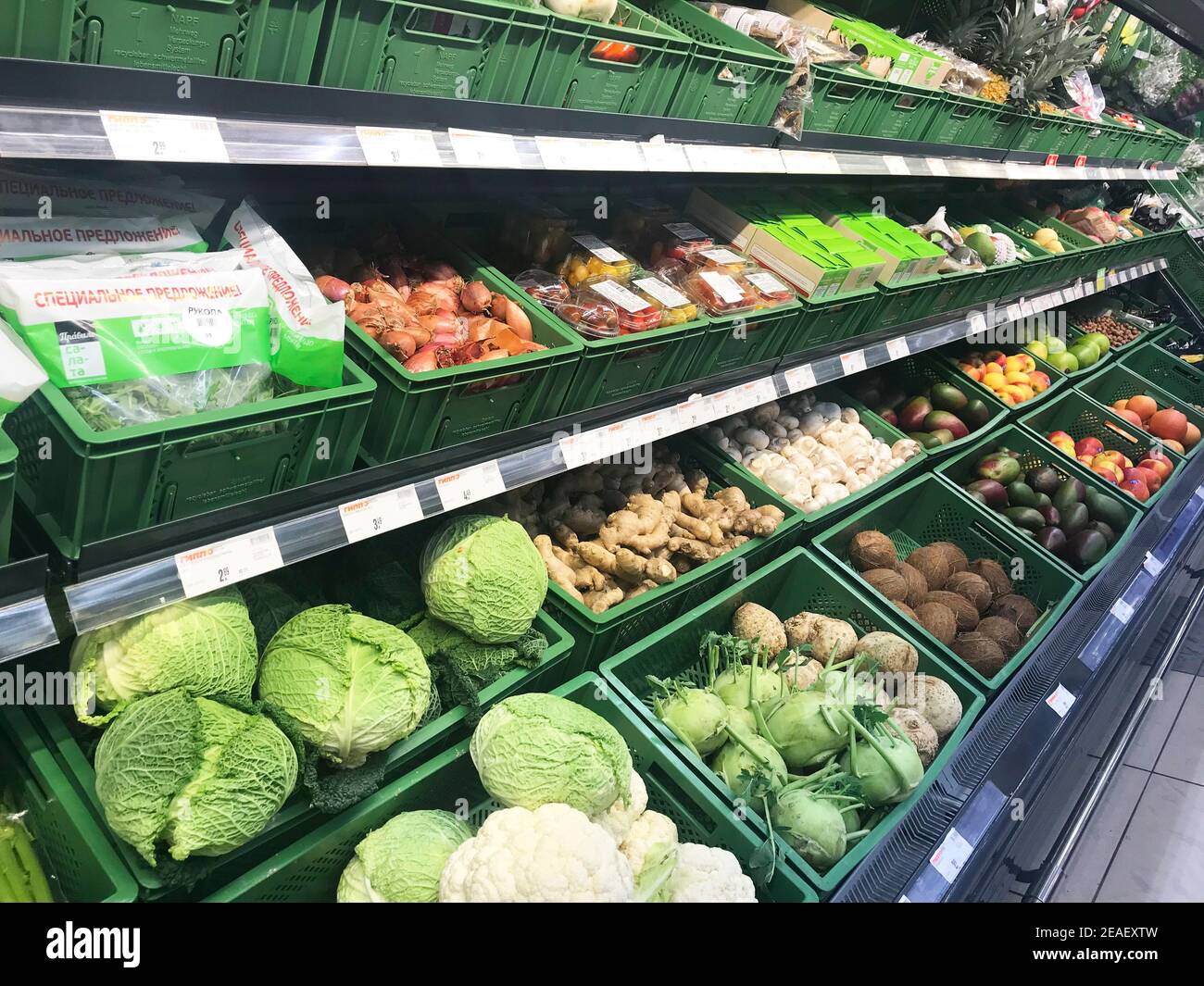 Different fresh vegetables in boxes on supermarket shelves, for sale ...