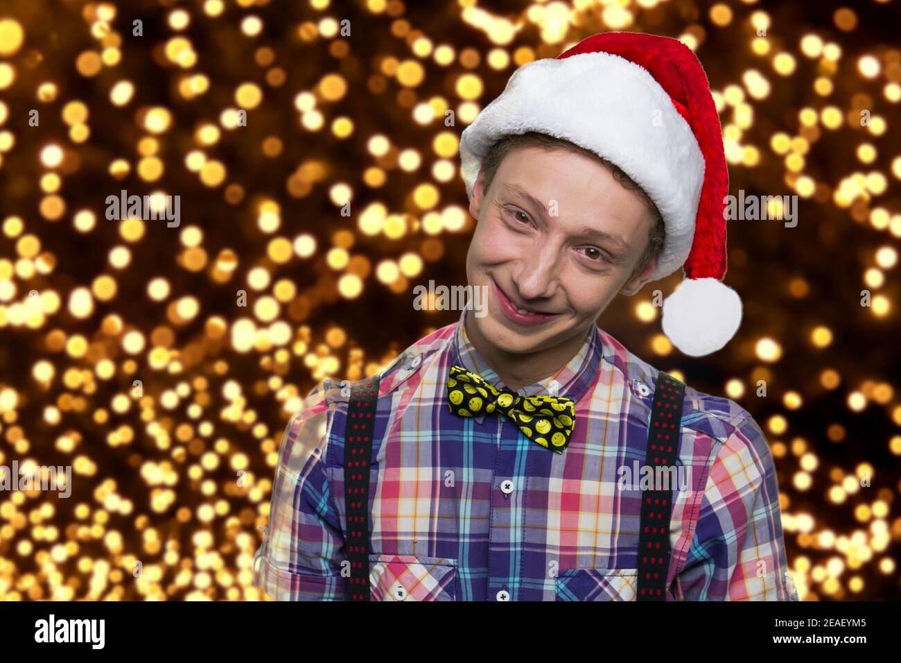 Positive young boy in santa hat. Stock Photo