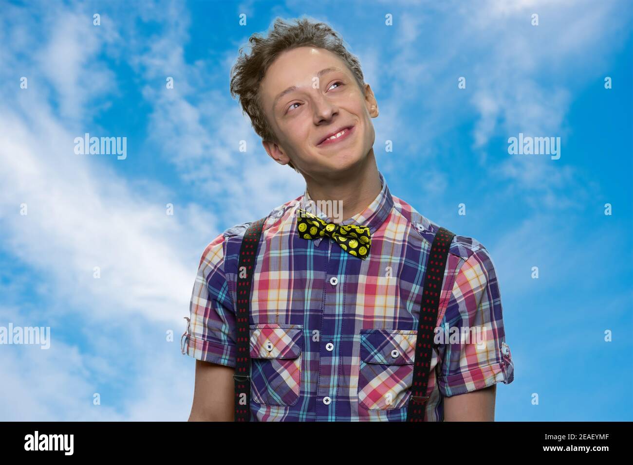 Smiling young boy is dreaming. Stock Photo