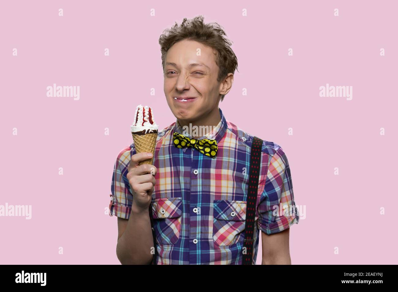 Smiling boy is eating icecream. Stock Photo