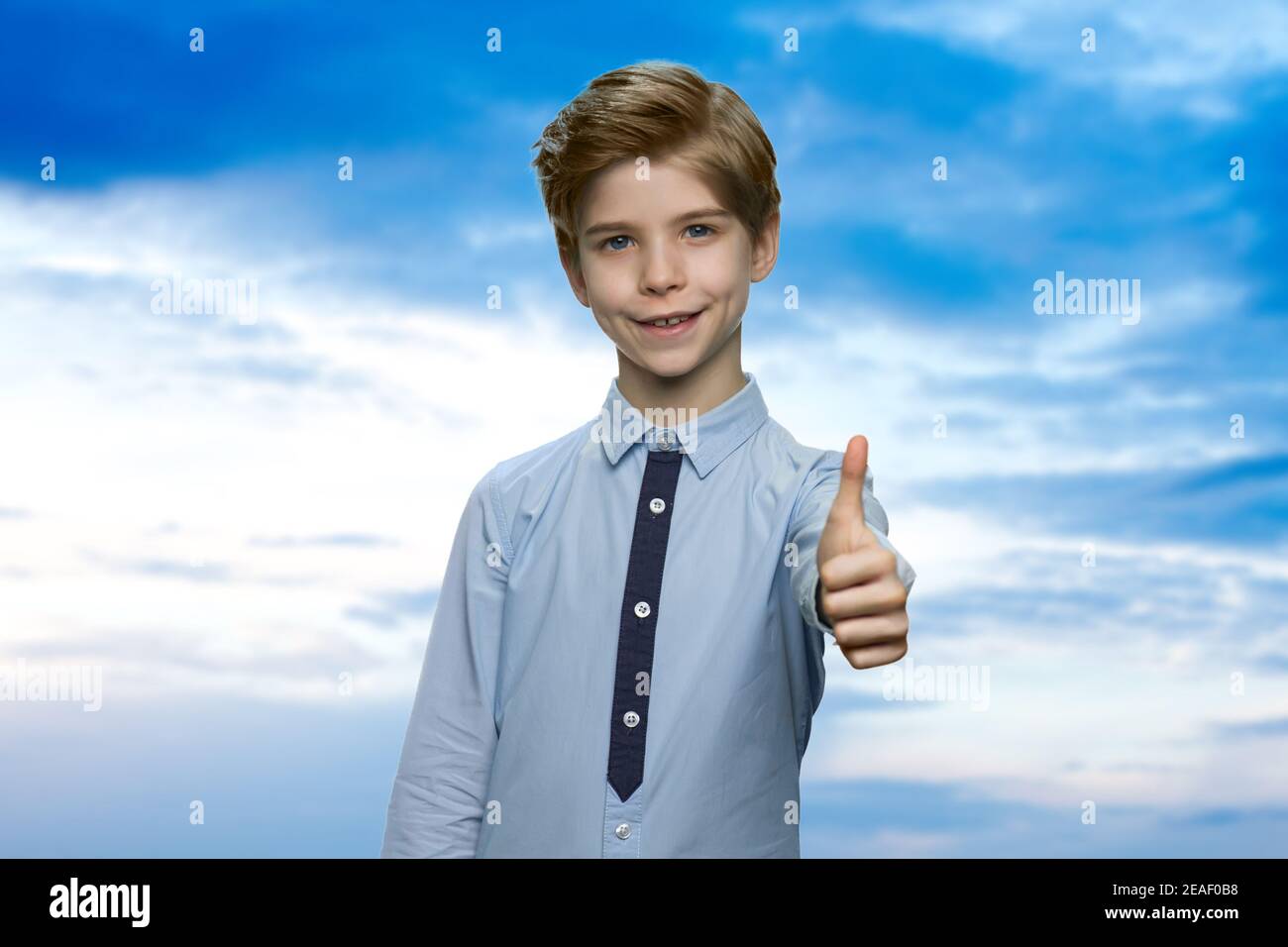 Adorable little boy is showing thumb up Stock Photo - Alamy