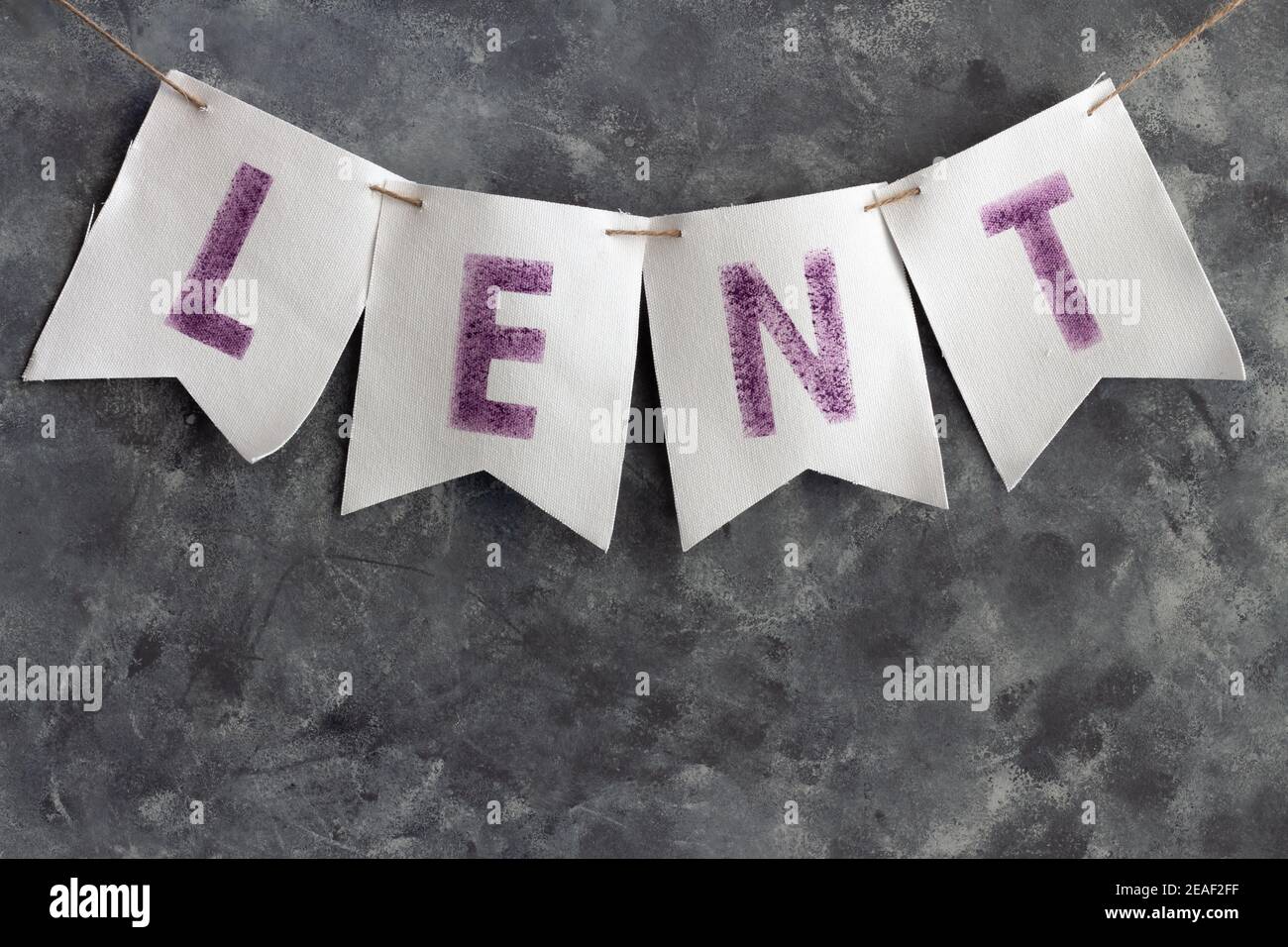 Lent word white cloth banner on dark background Stock Photo - Alamy