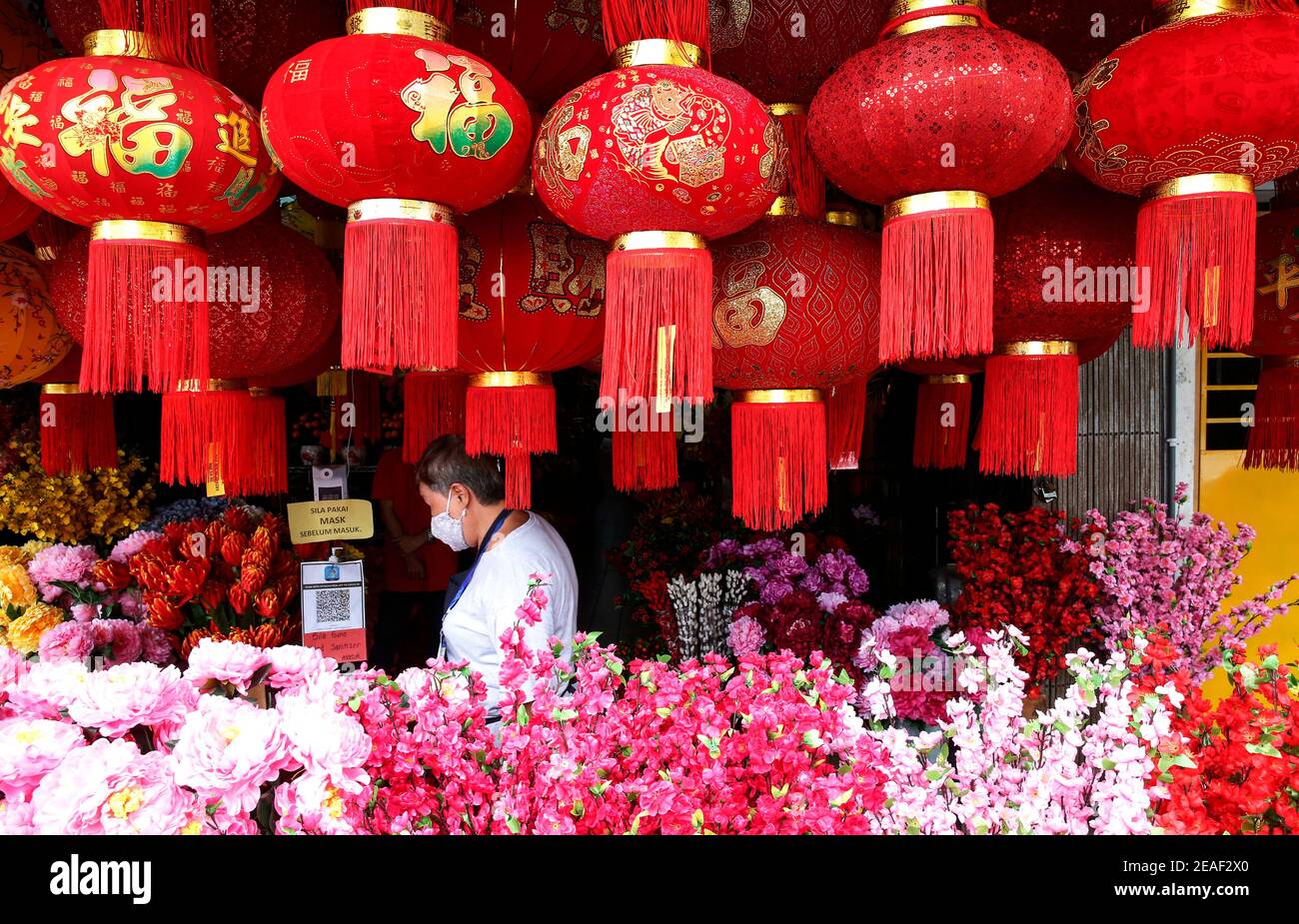 A Woman Looking Through The Chinese New Year Lantern Decoration In China Town Chinese Around The World Will Be Celebrating The Chinese Lunar New Year And Welcome The Year Of Ox Which Falls