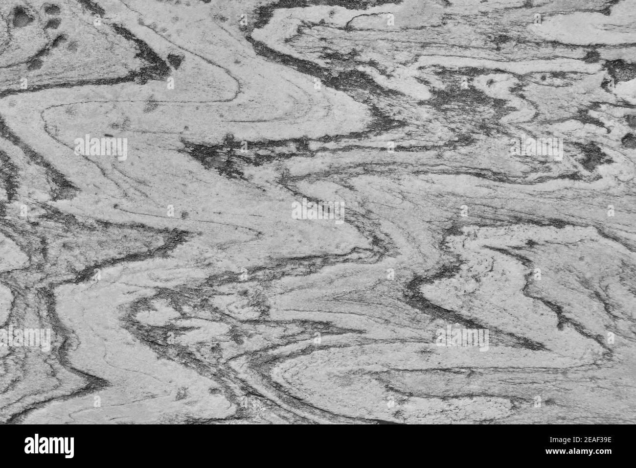 Rock texture with curved lines. Background old stone surface. Stock Photo