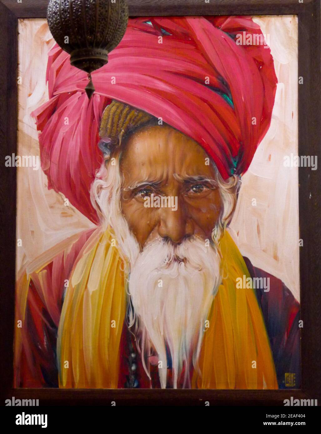 Picture of elderly Tuareg man, with a long white beard, on a Marrakesh cafe wall. Wearing a reddish turban. Marrakesh, Morocco. Stock Photo