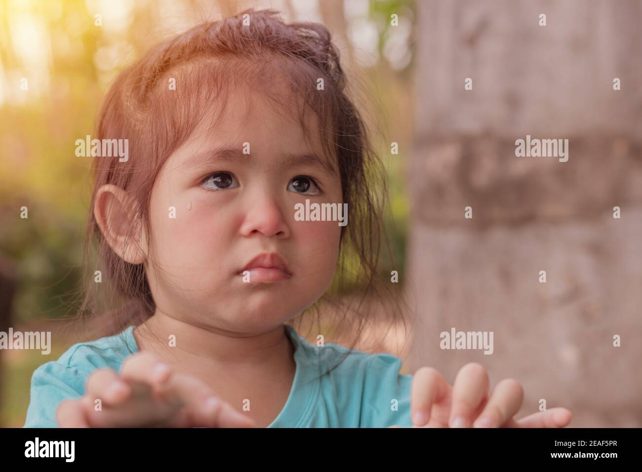 Close-up of an Asian kid girl frustrating and crying and sad.She has a negative attitude,ADHD concept. Stock Photo
