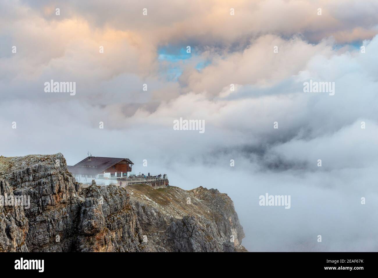 The Lagazuoi alpine refuge in the Lagazuoi mountain group. The Ampezzo Dolomites. Clouds in sky at sunset. Italian Alps. Europe. Stock Photo