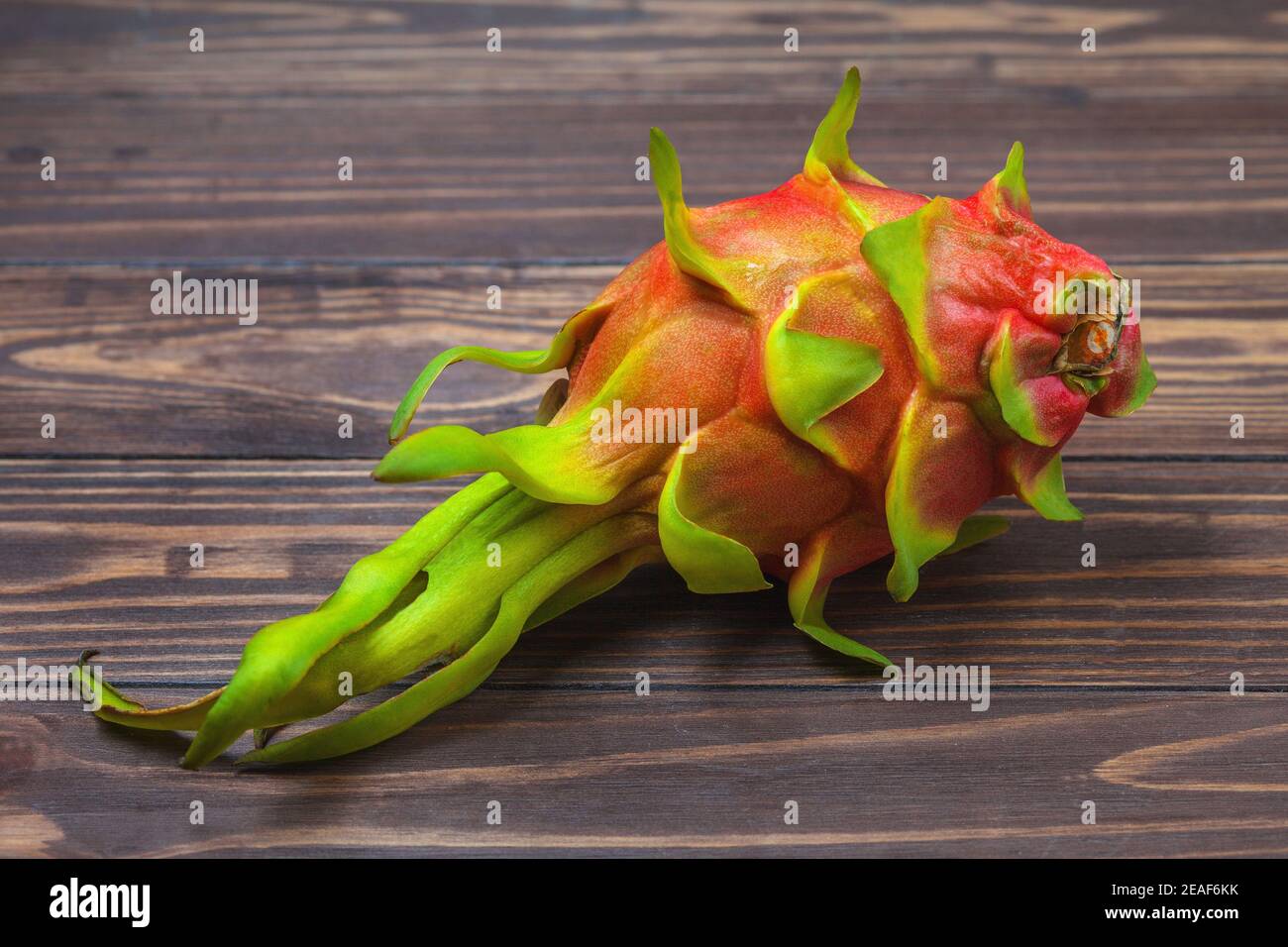 Red pitahaya. Ripe pitahaya fruit lies on a background of wooden boards. High quality photo Stock Photo