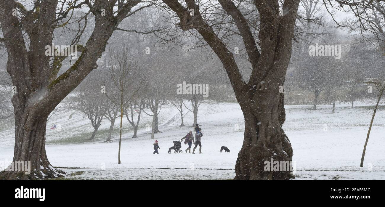 Hay Lodge Park, Peebles, Scottish Borders. UK. 9th Feb 21 Border 's family make their way home during snow shower after outing to Hay Lodge Park, in Peebles Credit: eric mccowat/Alamy Live News Stock Photo