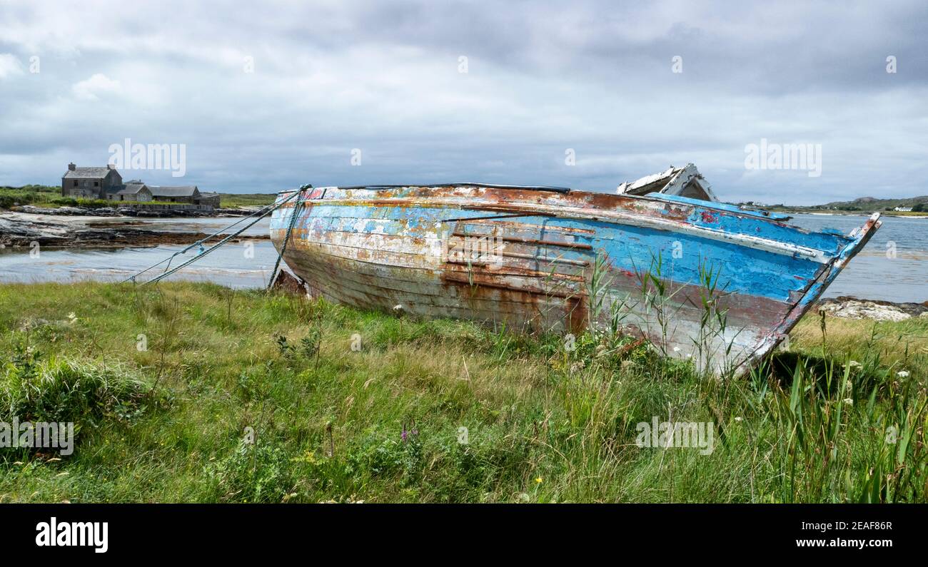 Derelict boat beached near Ballyconneely in Connemara on the west coast of Ireland Stock Photo