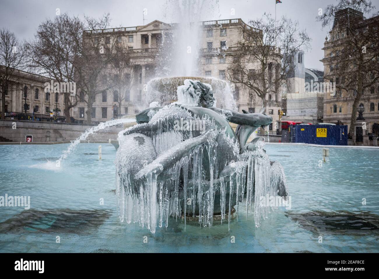UK Weather: Storm Darcy: Icicles hang from the mermaid fountain statues in Trafalgar Square, London, UK. Stock Photo