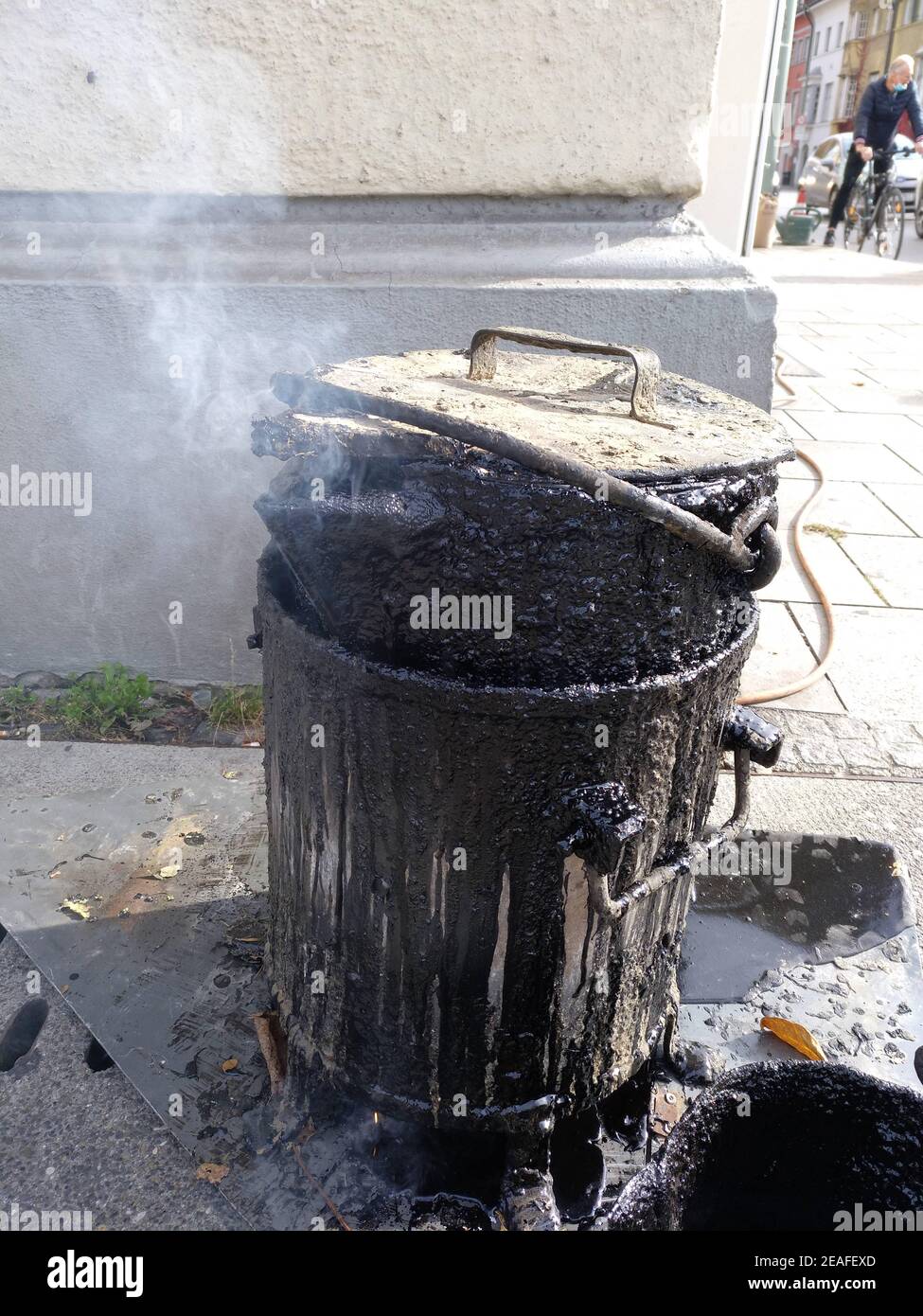 Asphalt melting in a electric pot on roadside Stock Photo Alamy