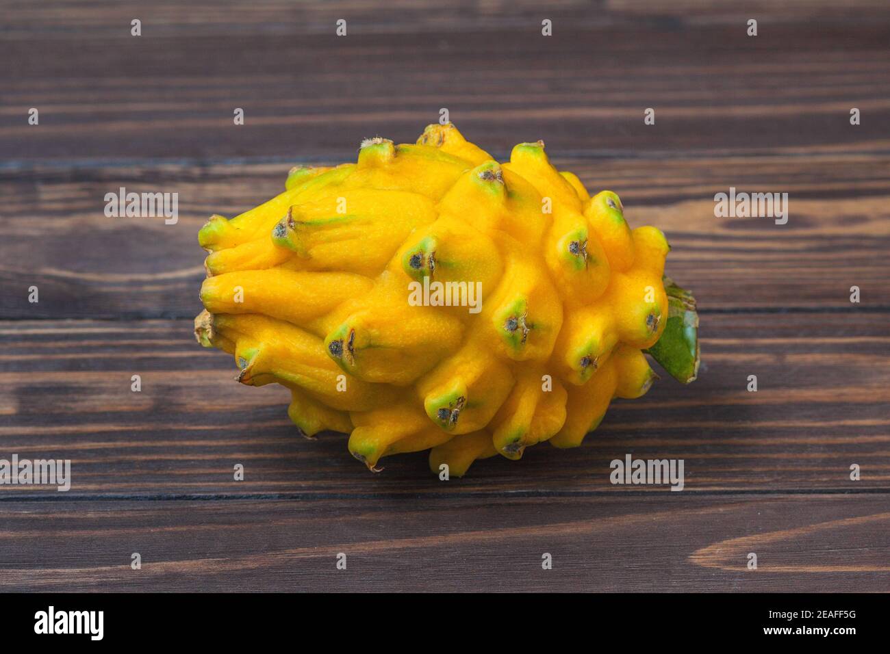 Ripe yellow pitahaya fruit, lie on a background of wooden boards. High quality photo Stock Photo