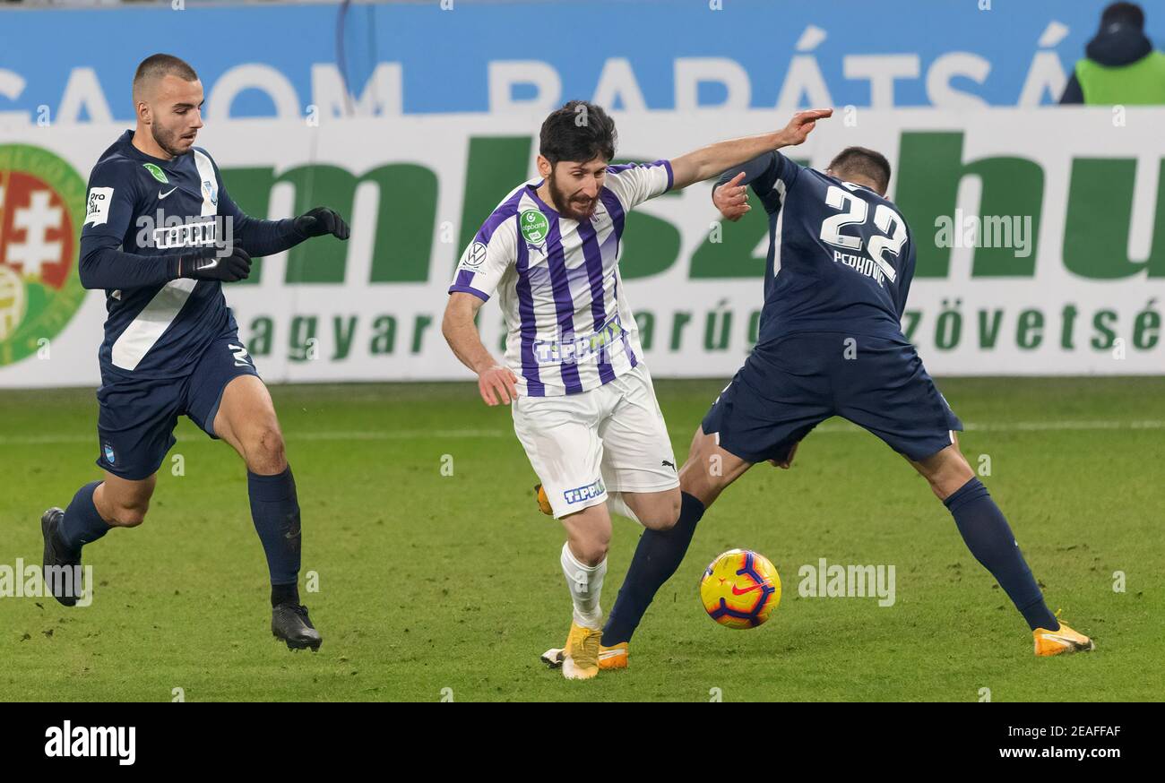 Budapest Hungary February 6 Giorgi Beridze Of Ujpest Fc L2 Tries To Break Out Between Benedek Varju Of Mtk Budapest L And Marko Perkovic Of Mtk Budapest During The Hungarian Otp