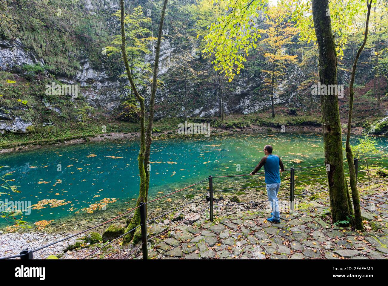 Man enjoy view of Wild lake near Idrija Stock Photo