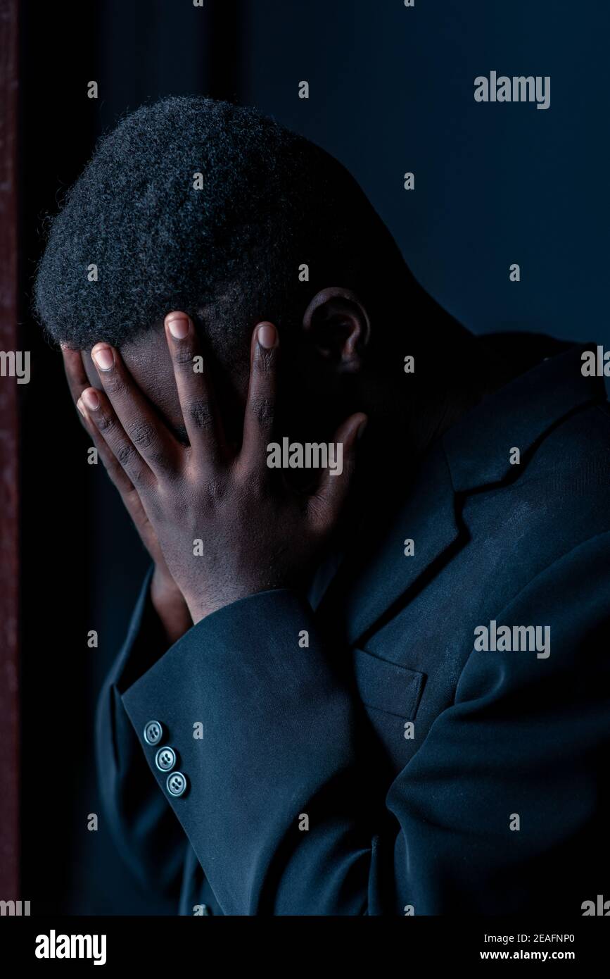 Stress african man in dark room , Low key style Stock Photo