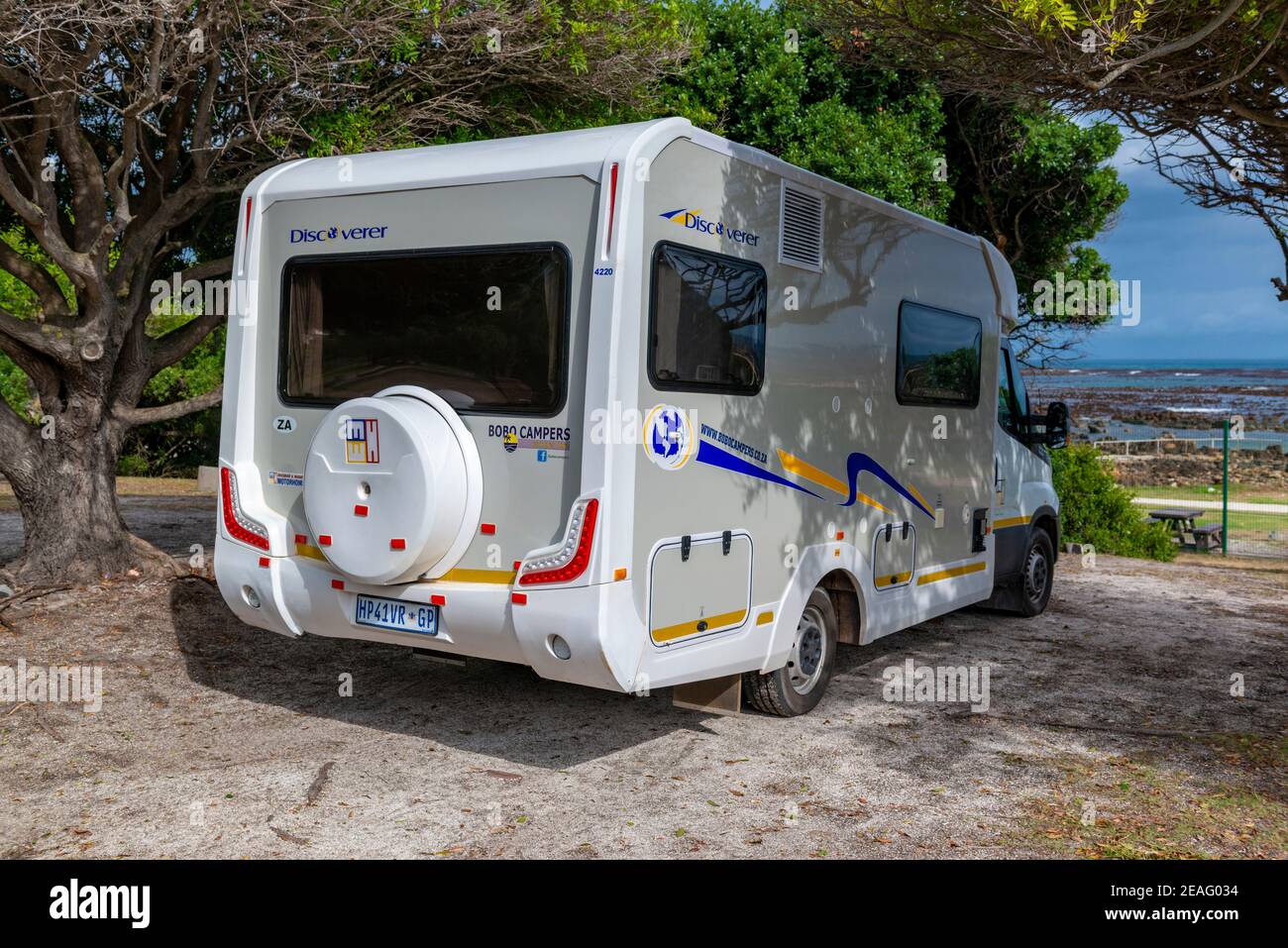 Motorhome pitched on site at Onrus Caravan Park uniquely situated right on the coast,with view of Davies' Pool a Rock Swmming pool on the Garden Route Stock Photo