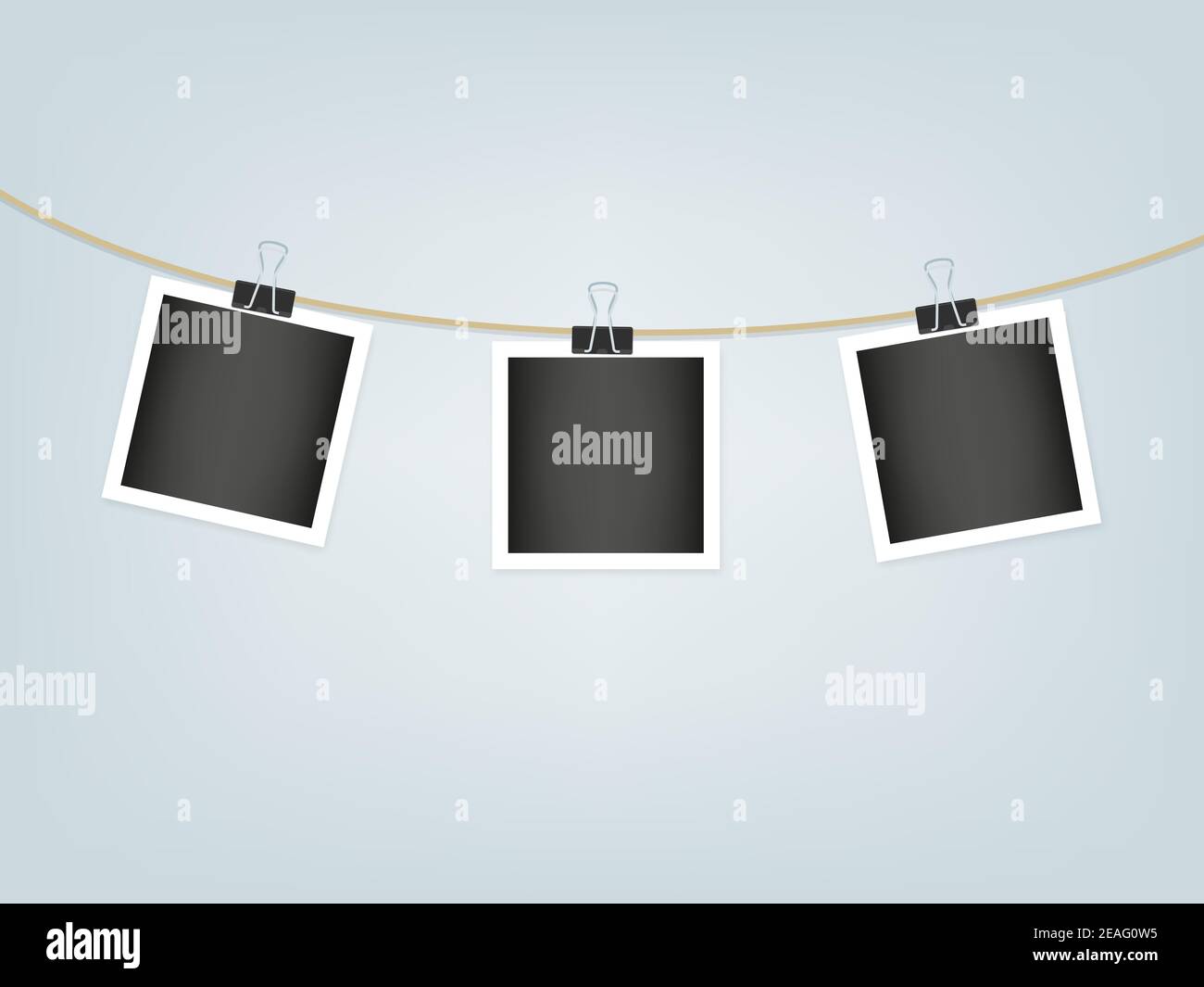 Photo frames hanging on rope with paper clips. White textured border