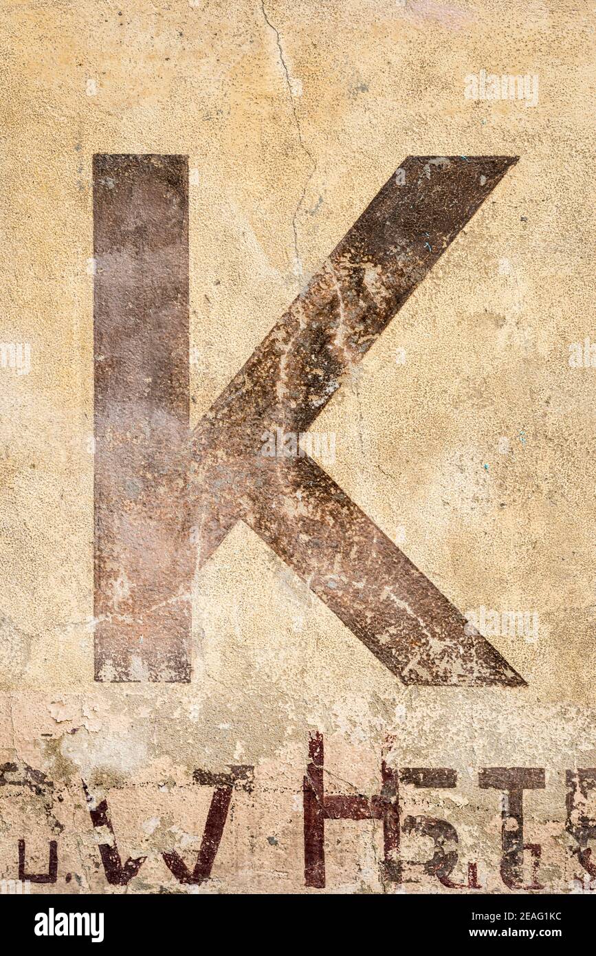 Painted letter K on a weathered house wall Stock Photo