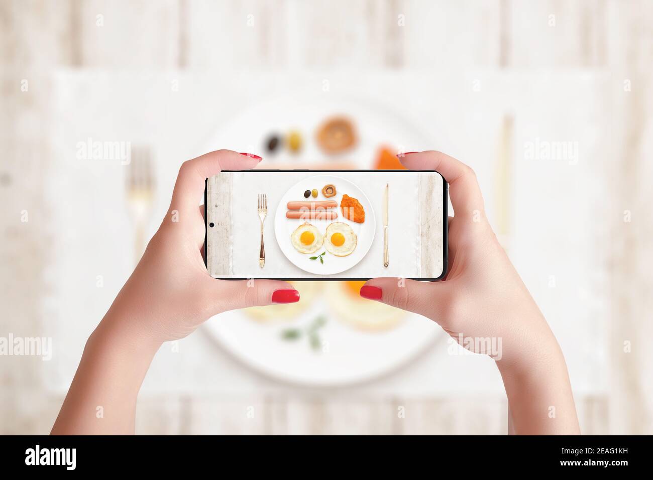 Taking photo of breakfast with phone. Woman holding smart phone in horizontal position Stock Photo