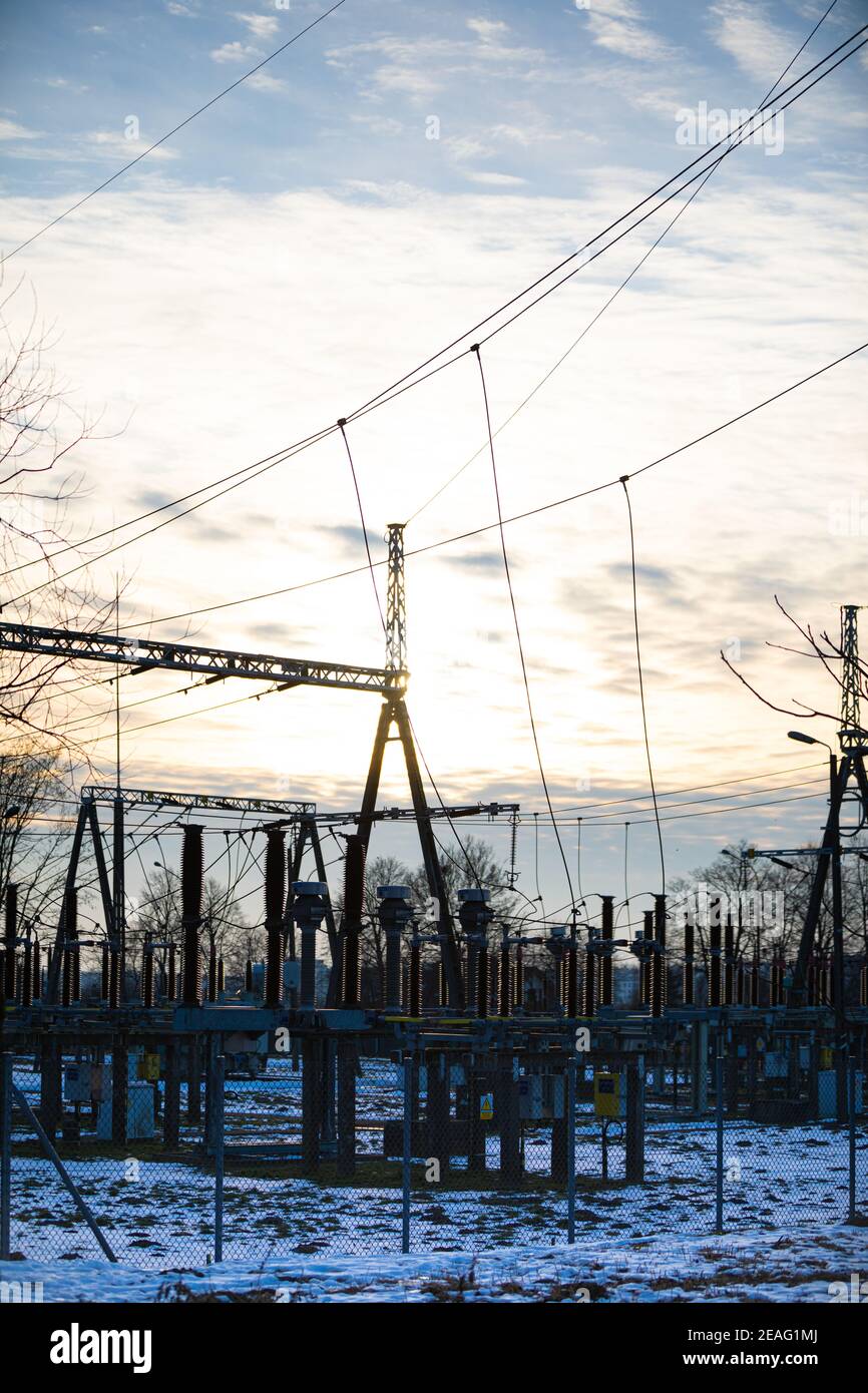 Modern and industrial, high voltage electrical power relay station with a suspended lightning protection system. Set of transformers and electrical connectors on the high voltage and medium voltage side. Stock Photo