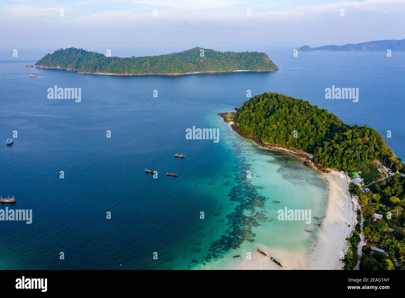 Aerial drone view of traditional longtail fishing boats in a lagoon on a tropical island (Kyun Phi Lar, Myanmar) Stock Photo