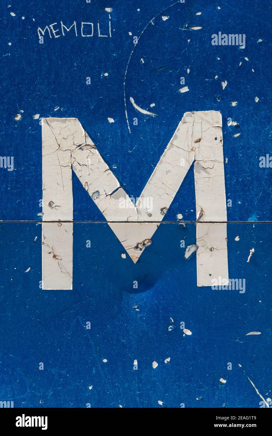 White letter M on a blue traffic sign Stock Photo Alamy