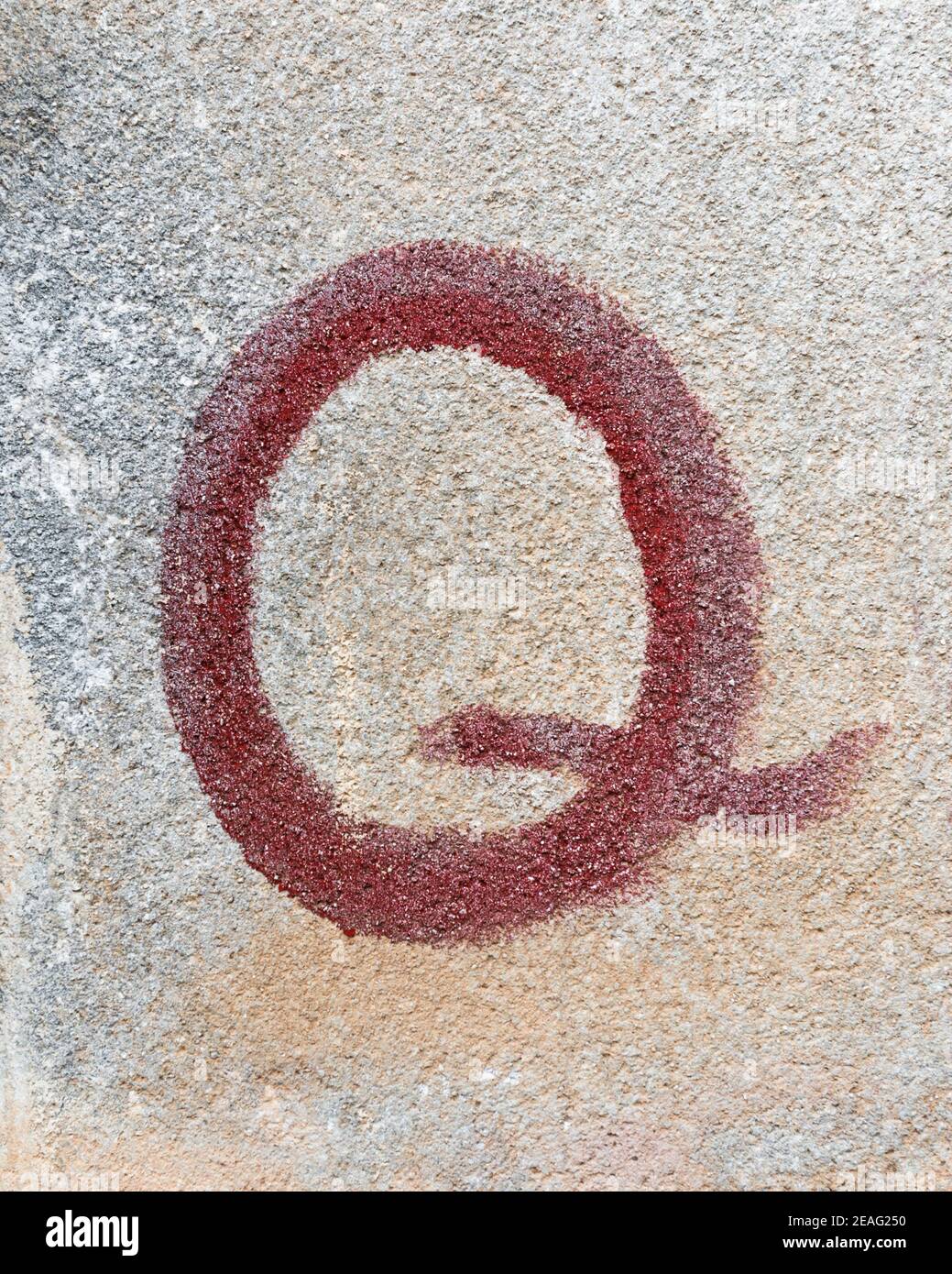 Red graffiti of a letter Q Stock Photo
