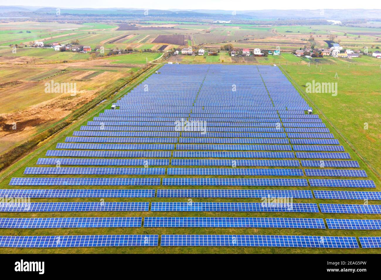 Aerial view of solar power plant on green field. Electric farm with