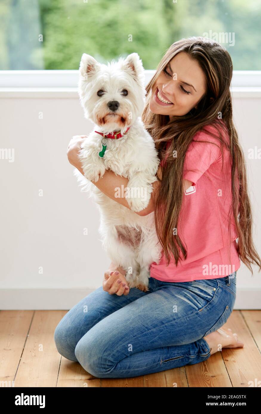 Woman sat with her pet dog Stock Photo