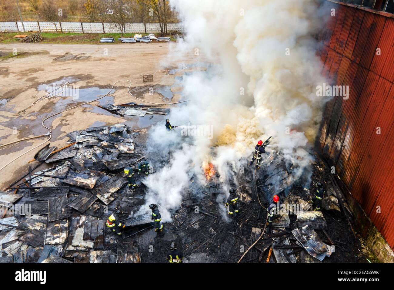Aerial view of firefighters extinguishing fire in industrial area Stock ...