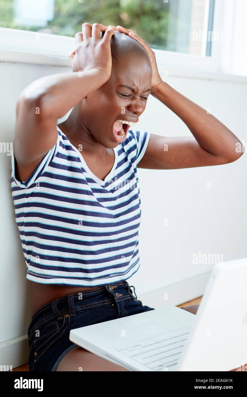 Ethnic Student girl sat on the floor studying Stock Photo