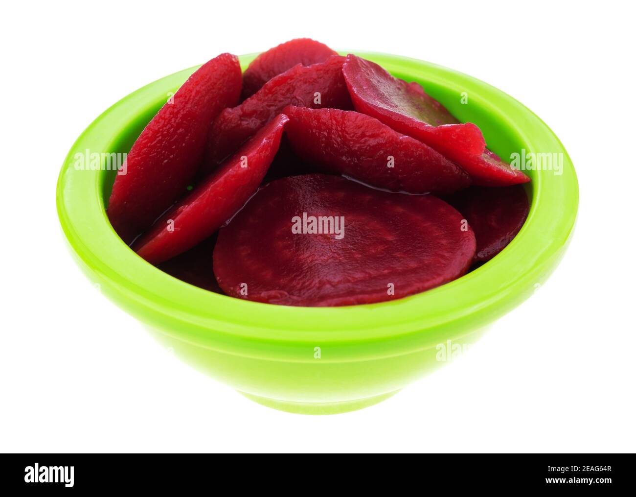 Side view of canned sliced beets in a small green bowl isolated on a white background. Stock Photo