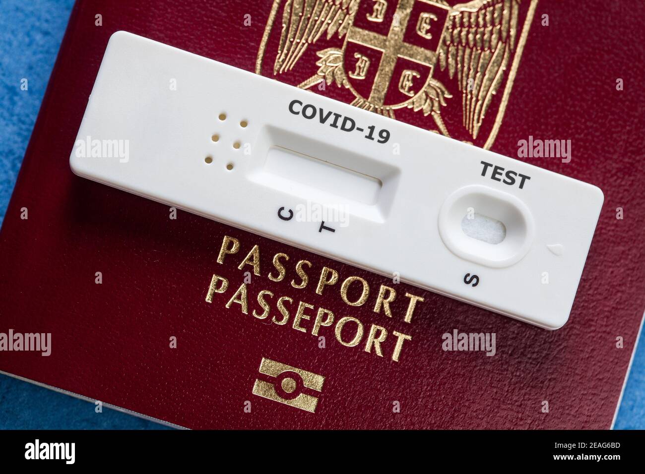 COVID-19 serological rapid diagnostic test on a Serbia passport,point of care testing procedure,immunity passport or health passport concept,risk free Stock Photo