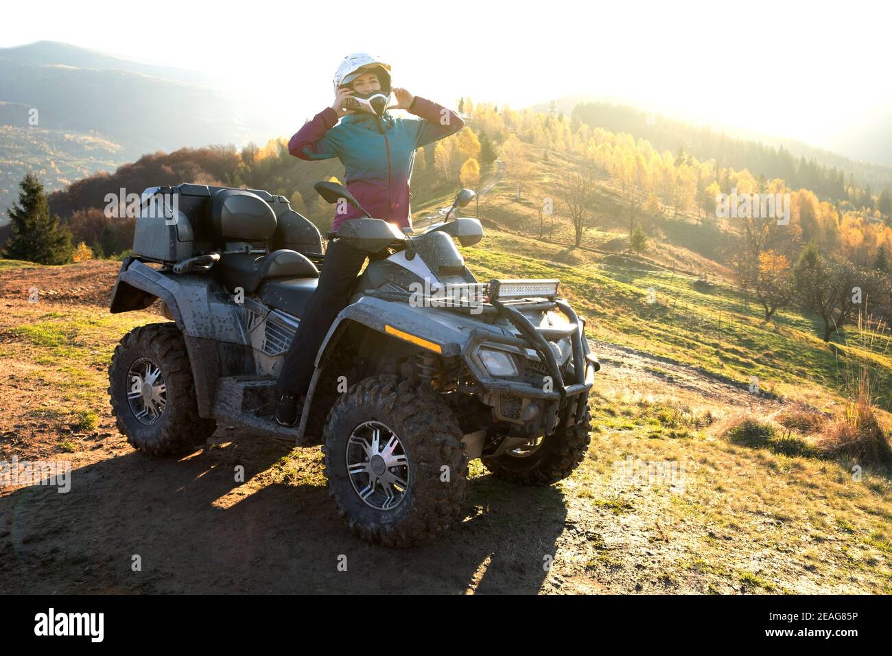 Happy woman driver in protective helmet enjoying extreme riding on ATV quad  motorbike in summer mountains at sunset Stock Photo - Alamy