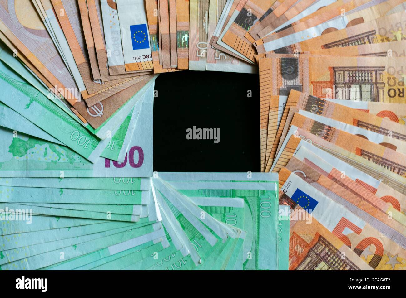 Many hundred and fifty euro bills forming an empty square inside the image. Stock Photo