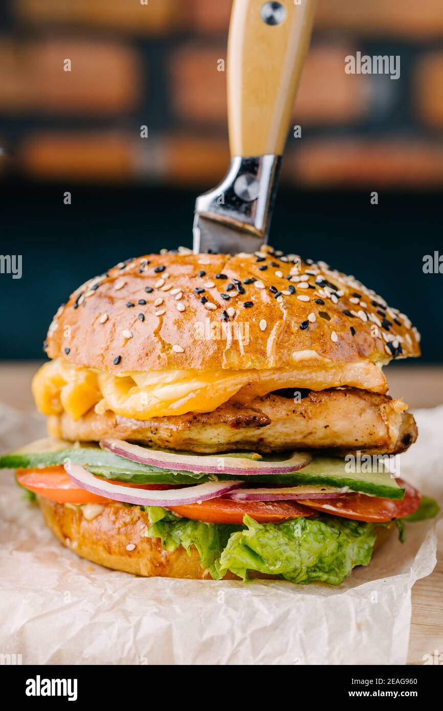 Delicious juicy burger close up from Brioche Bun. Chicken steak, cheese