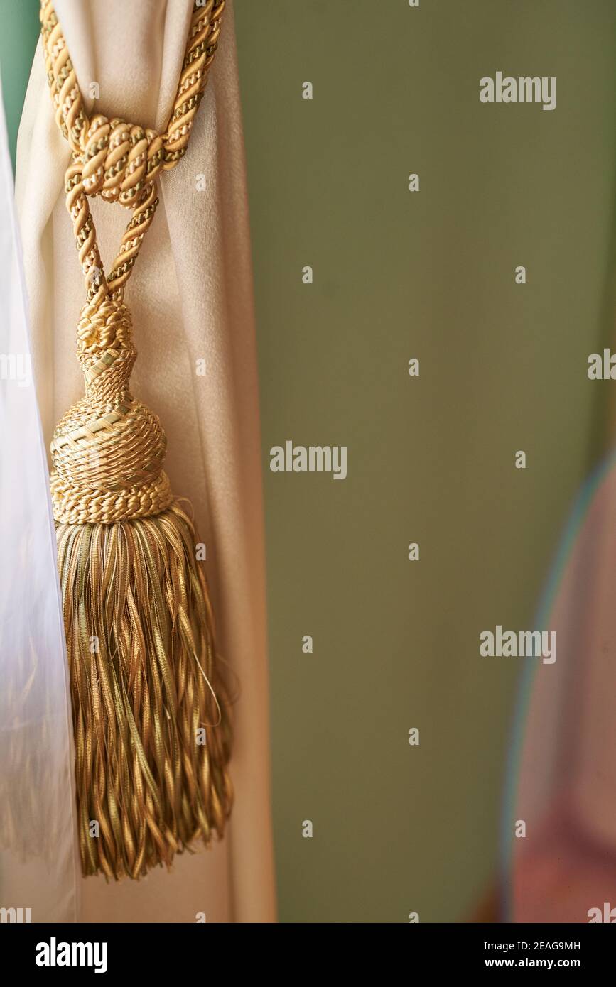 Yellow curtain holder with tassels Stock Photo Alamy