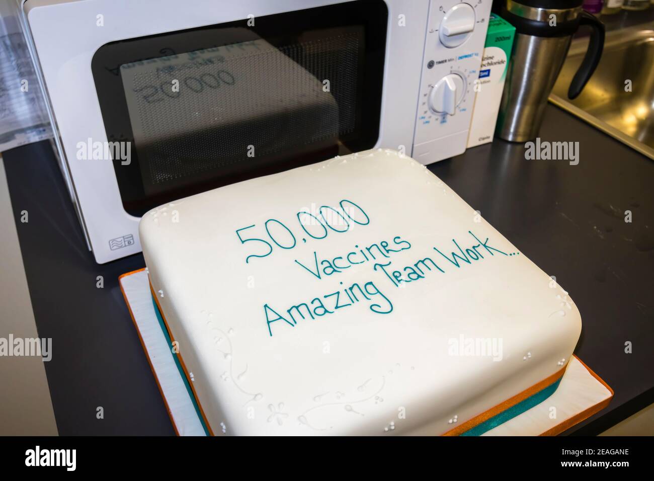 Cake at the Covid-19 vaccinations site in Woking, Surrey, south-east England celebrating 50,000 vaccines by the local NHS staff team Stock Photo