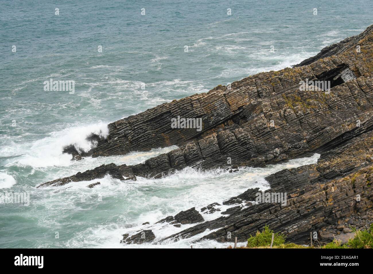 Waves crashing on the coastal cliffs Stock Photo