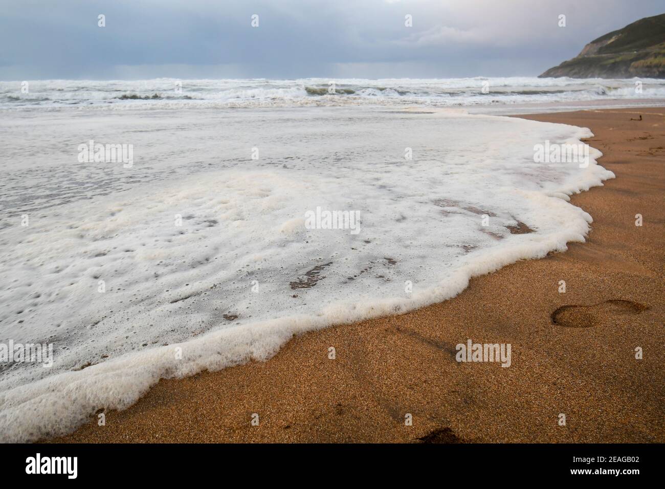 Foam of the waves on the beach sand Stock Photo Alamy