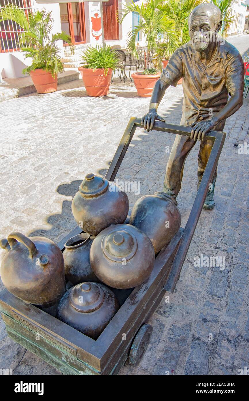A statue of a man pushing a cart of clay pots / tinajónes in Camagüey, Cuba Stock Photo