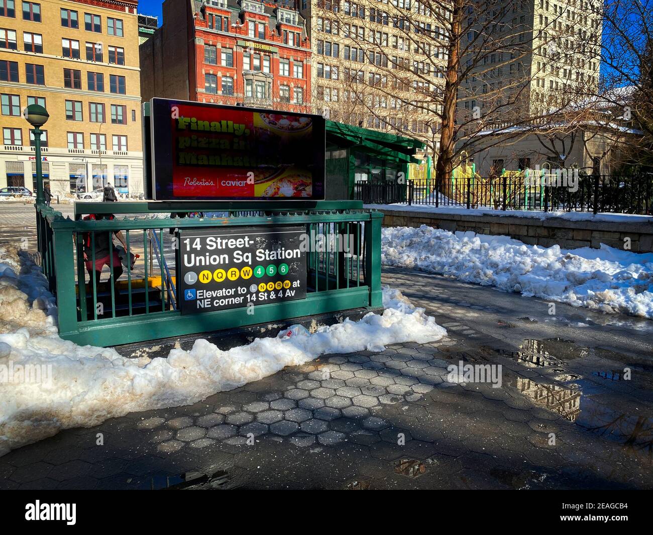 New York, NY, USA - Feb 9, 2021: Union Square subway entrance surrounded by snow Stock Photo