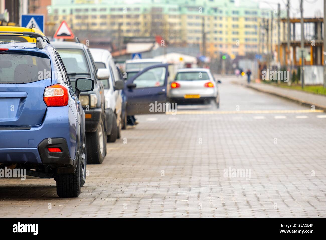 Cars parked in a row on a city street side Stock Photo - Alamy