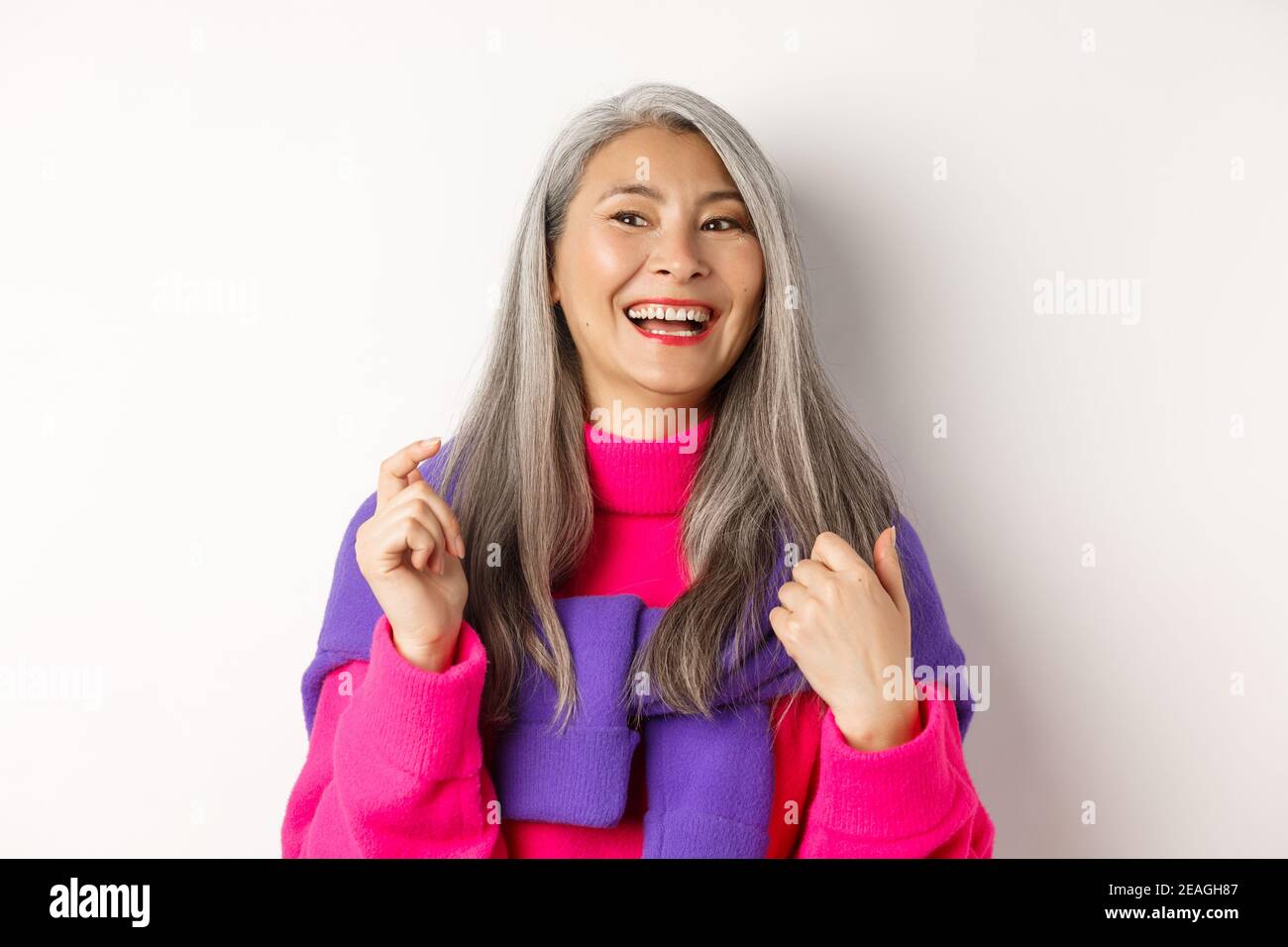 Close Up Of Fashionable Asian Senior Woman Laughing And Having Fun Looking Left Cheerful