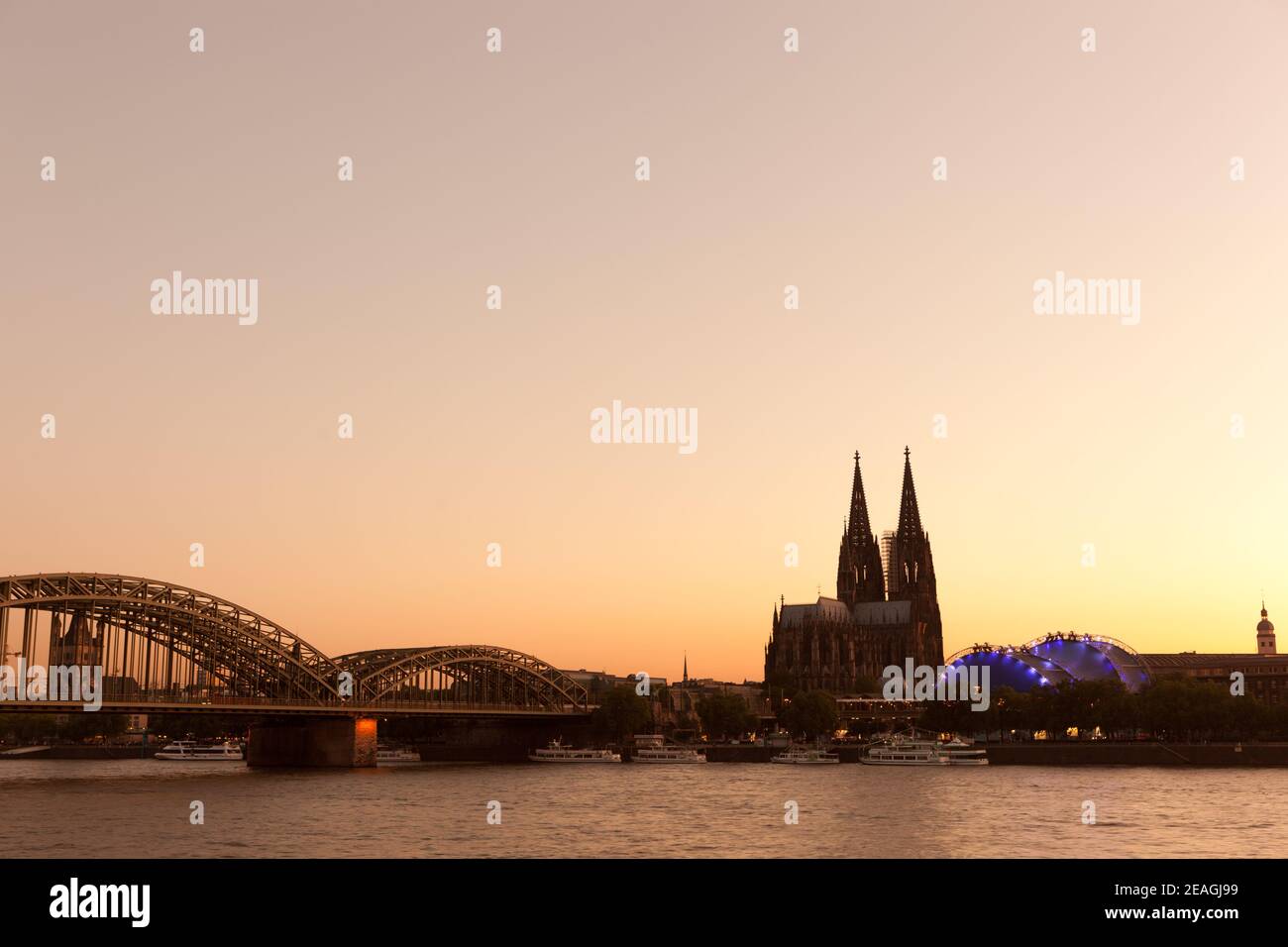 Cologne Germany Cologne Cathedral and Hohenzollern Bridge at sunset. Stock Photo