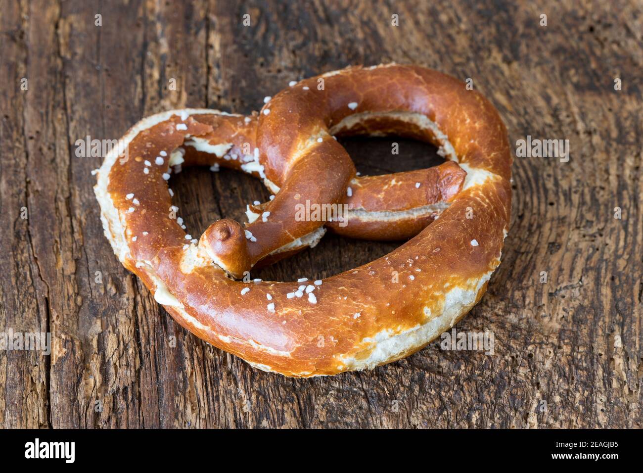 bavarian butter pretzel on dark wood Stock Photo